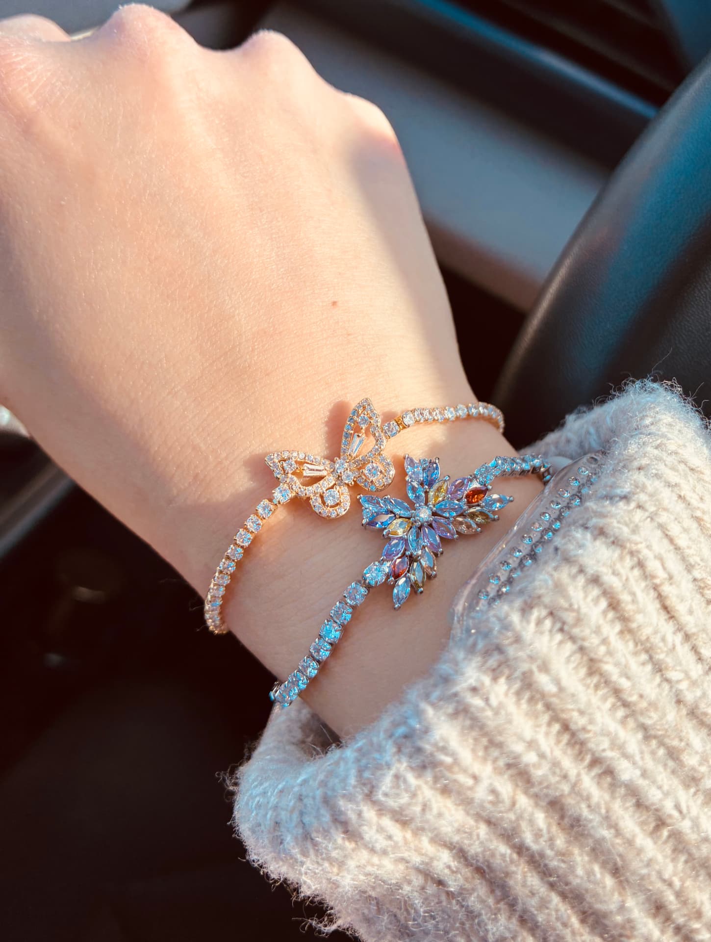 Close-up of the Wings of Hope butterfly bracelet catching the light on the wrist